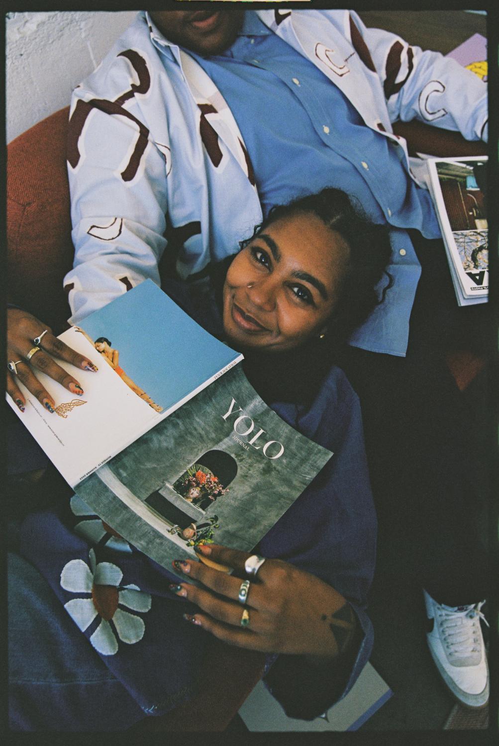 A reader with a copy of YOLO Journal